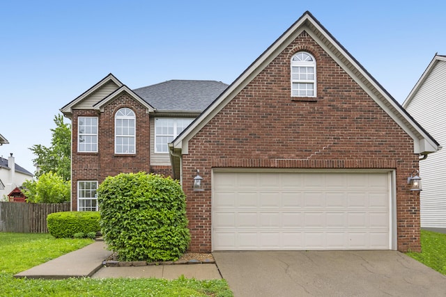 traditional home with brick siding, driveway, fence, and a shingled roof