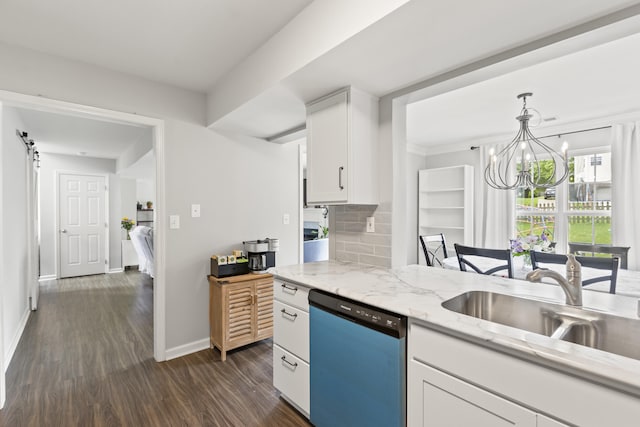 kitchen with dishwasher, white cabinets, dark wood finished floors, a chandelier, and decorative backsplash