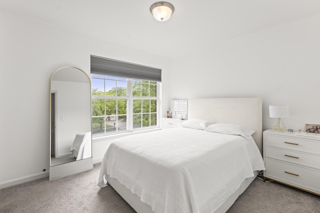 bedroom with carpet and baseboards