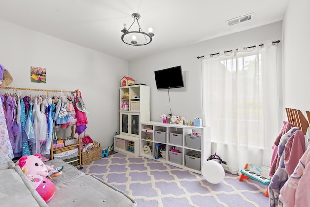 rec room with a chandelier