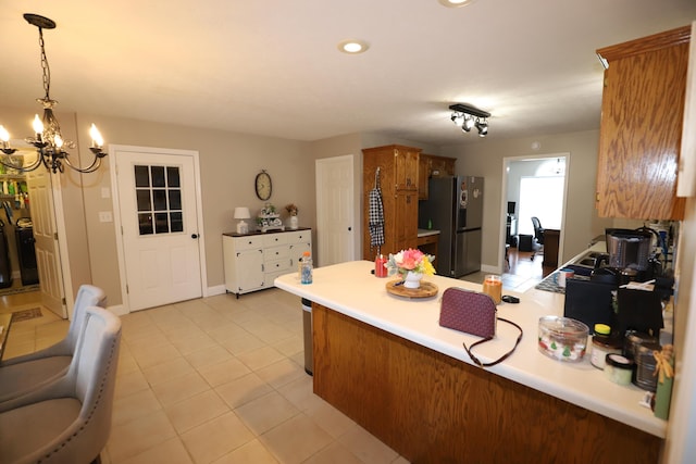 71 View Point Dr, Somerset, KY 42503 - kitchen featuring fridge with ice dispenser, a peninsula, a chandelier, brown cabinetry, and light tile patterned flooring