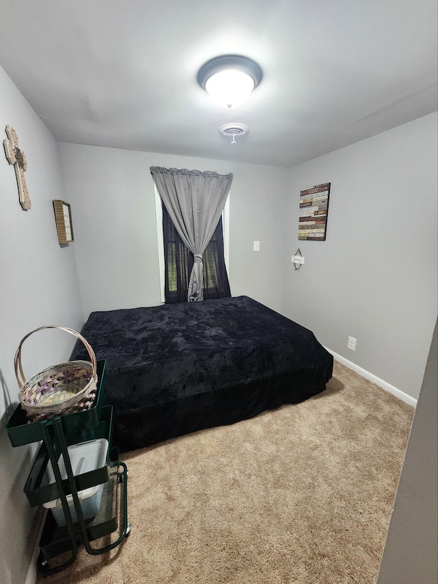 carpeted bedroom featuring baseboards