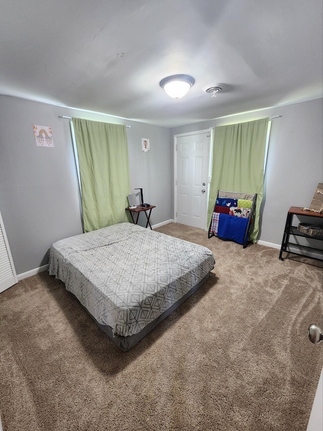 carpeted bedroom featuring baseboards