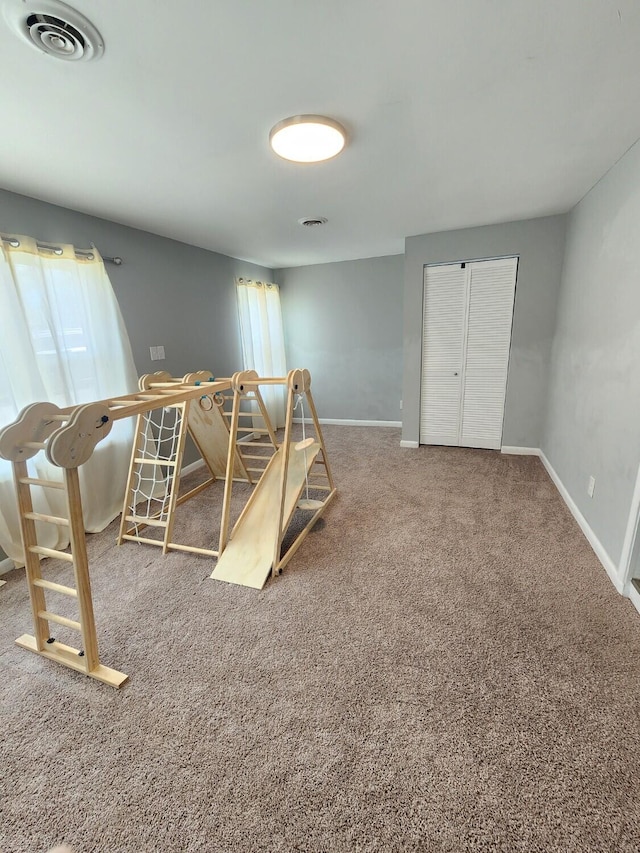 bedroom with carpet flooring, baseboards, and a closet