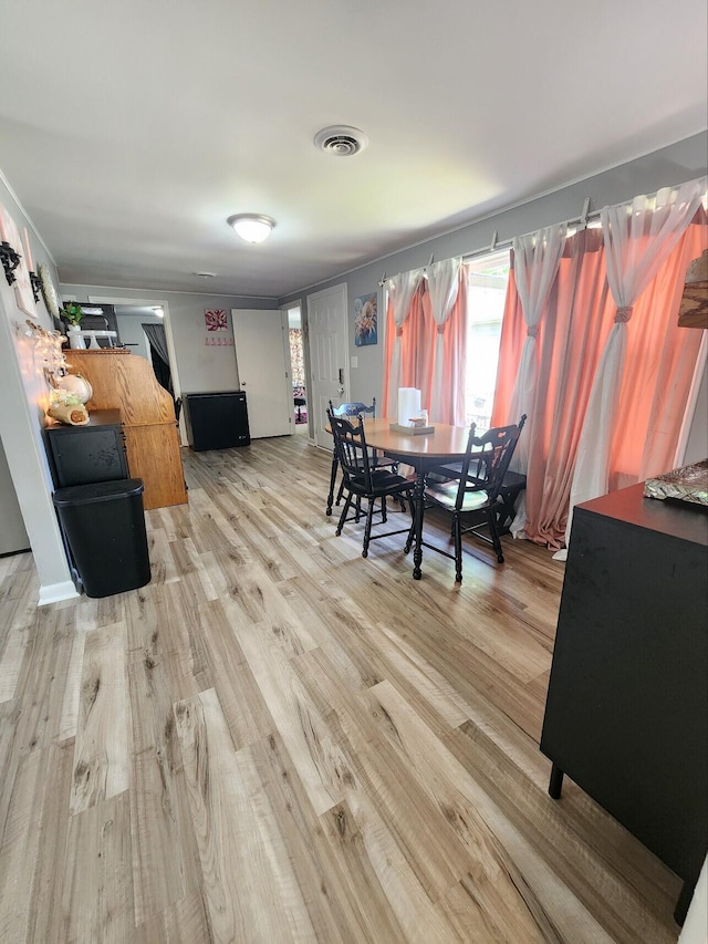dining area featuring light wood-type flooring