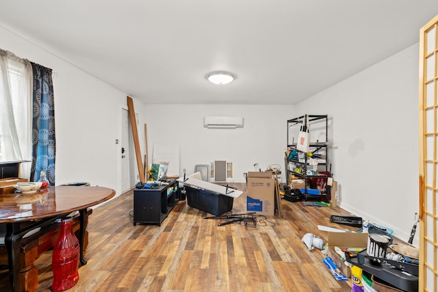 office space featuring an AC wall unit and hardwood / wood-style flooring