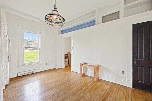 unfurnished dining area with hardwood / wood-style floors and baseboards