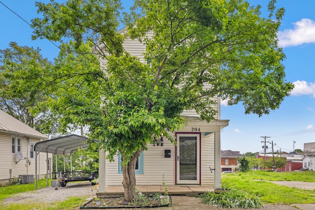 view of front of property with a detached carport and dirt driveway
