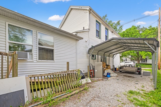view of side of home with a carport and cooling unit