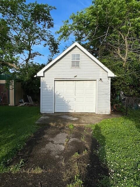 detached garage featuring driveway