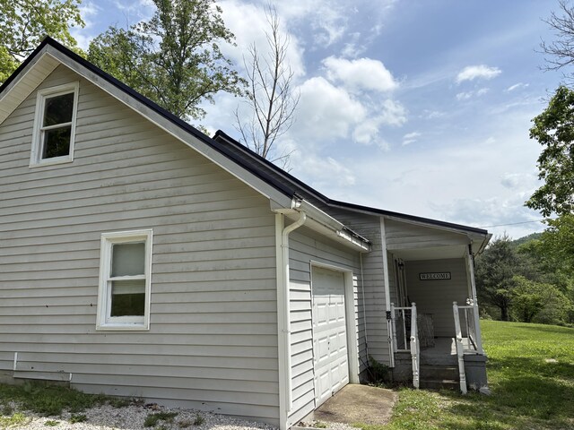 842 Lower Cane Creek Rd, Stanton, KY 40380 - view of property exterior with an attached garage and a lawn