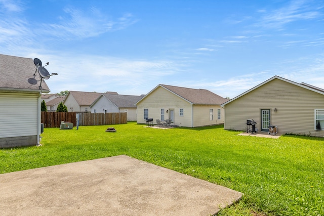 rear view of property with a patio area and a fire pit