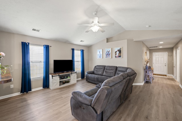 living room with wood finished floors, a ceiling fan, baseboards, and lofted ceiling