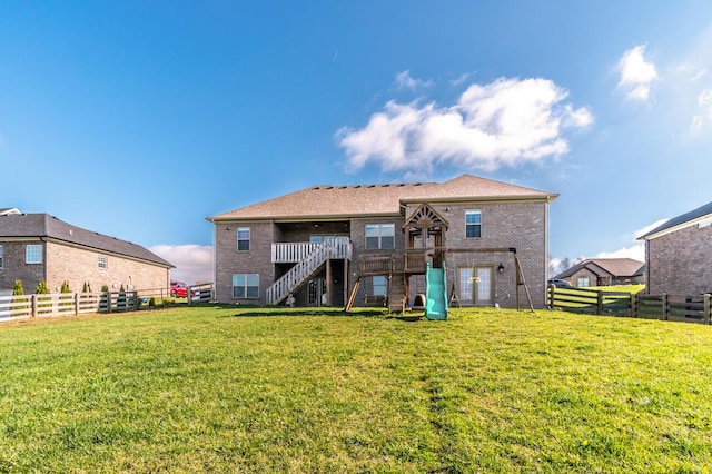 back of house with stairway, brick siding, and a deck