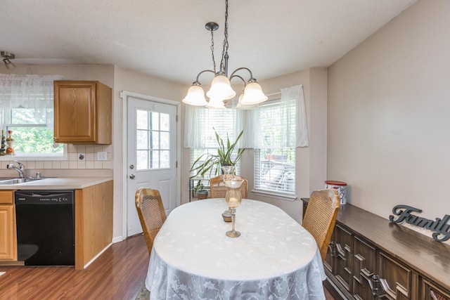 dining area with dark wood-style flooring and a chandelier