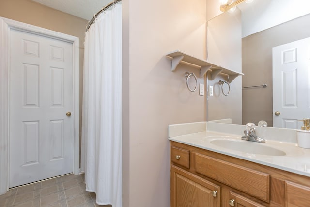 bathroom featuring vanity, tile patterned floors, and curtained shower