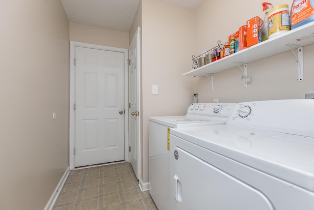 laundry area with baseboards and washer and clothes dryer