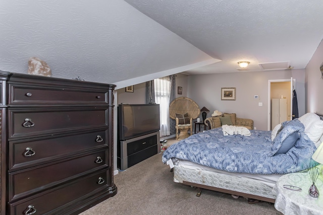 bedroom featuring carpet flooring and attic access