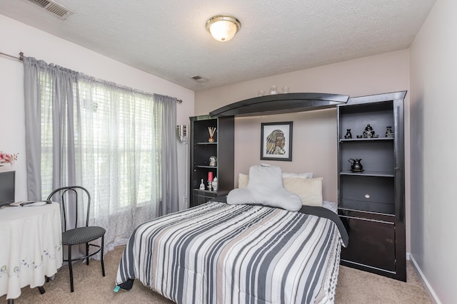 bedroom featuring carpet and a textured ceiling