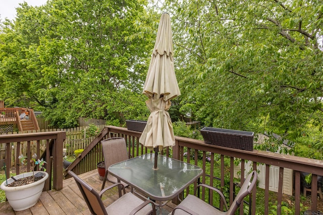 wooden deck featuring outdoor dining space and fence