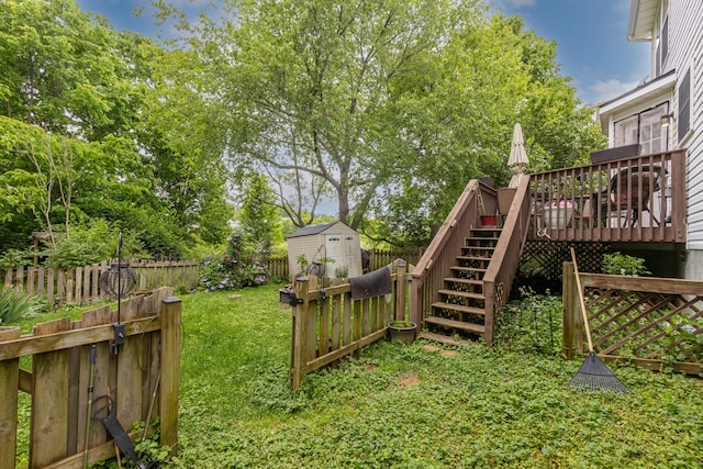 view of yard with a shed, stairway, a wooden deck, and an outdoor structure