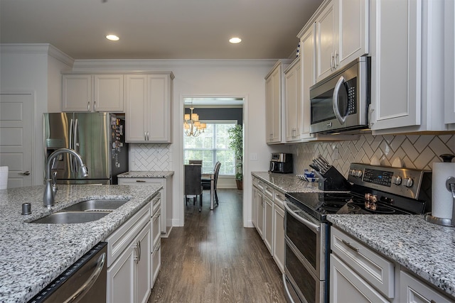465 Manitoba Ln, Lexington, KY 40515 - kitchen with stainless steel appliances, a sink, ornamental molding, a chandelier, and dark wood-style flooring