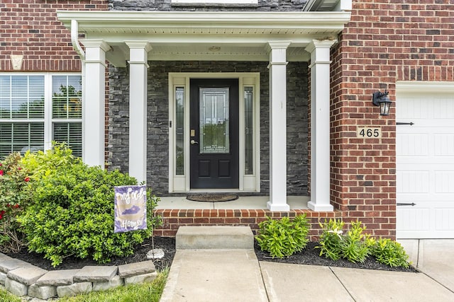 465 Manitoba Ln, Lexington, KY 40515 - entrance to property with a porch, a garage, and brick siding