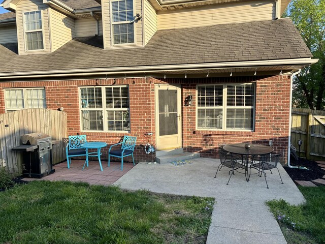 4336 Clearwater Way, Lexington, KY 40515 - rear view of house with brick siding, fence, a shingled roof, and a patio