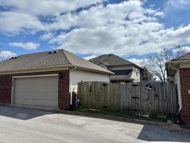 4336 Clearwater Way, Lexington, KY 40515 - view of side of home featuring brick siding, fence, a gate, and a shingled roof