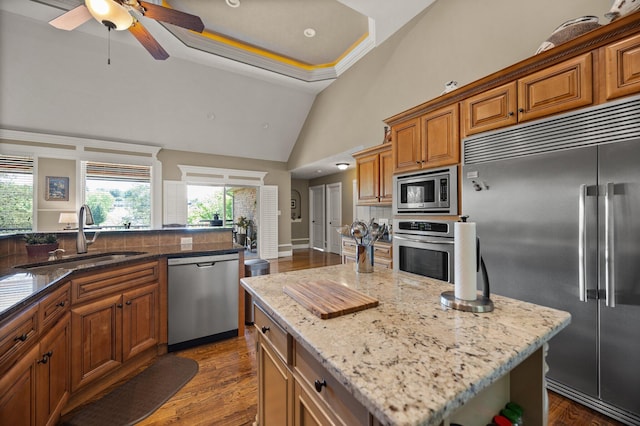 43 Enclave Dr, Somerset, KY 42503 - kitchen with built in appliances, a sink, brown cabinetry, plenty of natural light, and high vaulted ceiling
