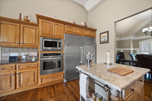 43 Enclave Dr, Somerset, KY 42503 - kitchen featuring built in appliances, lofted ceiling, light stone counters, brown cabinetry, and tasteful backsplash