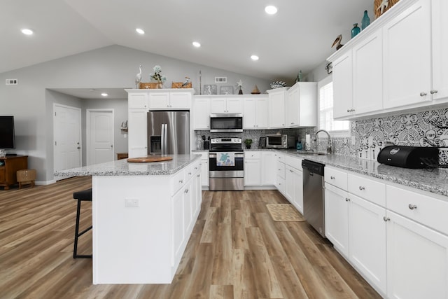 350 Misty Dr, Somerset, KY 42503 - kitchen with stainless steel appliances, lofted ceiling, a sink, backsplash, and white cabinetry