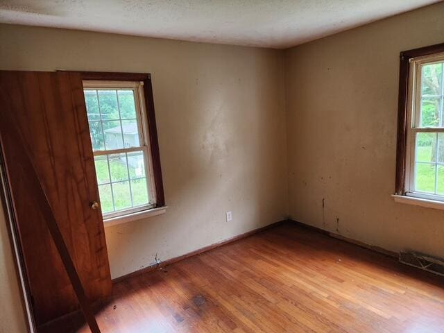 spare room featuring light wood-style flooring and baseboards