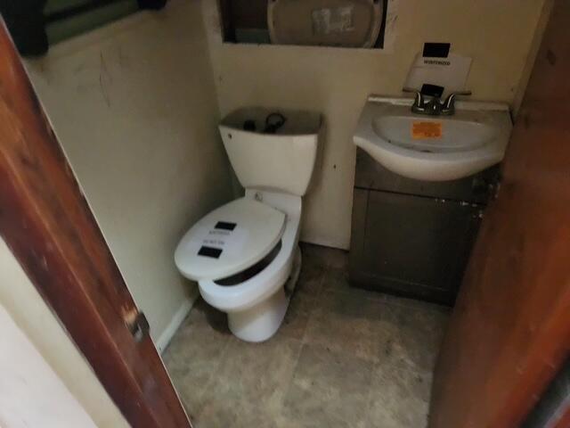 half bathroom with vanity and toilet