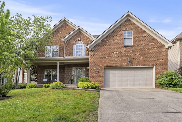 traditional-style home featuring an attached garage, concrete driveway, a front lawn, brick siding, and covered porch