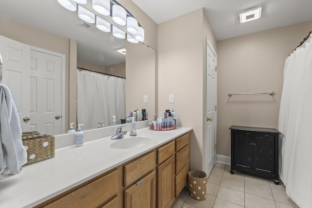 bathroom with tile patterned flooring and vanity