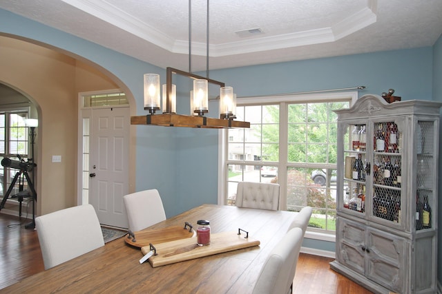 2812 Jenna Rst, Lexington, KY 40511 - dining space featuring arched walkways, wood finished floors, healthy amount of natural light, a raised ceiling, and ornamental molding
