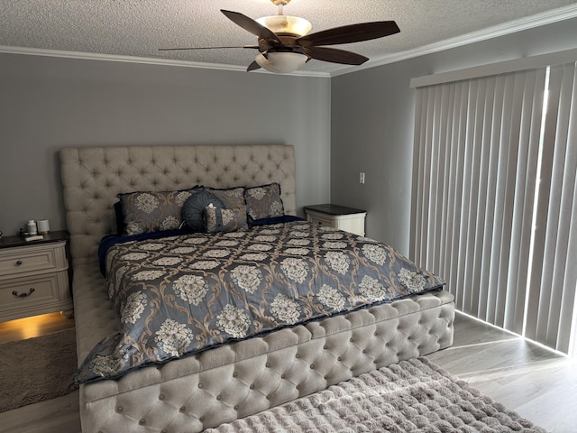 bedroom with wood finished floors, ornamental molding, a textured ceiling, and ceiling fan