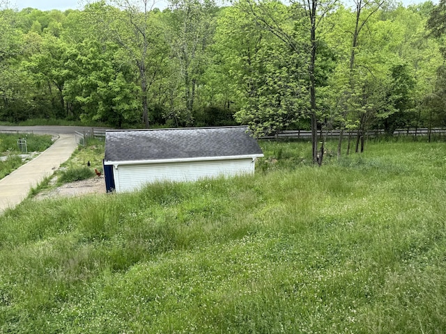 view of yard with a view of trees and fence