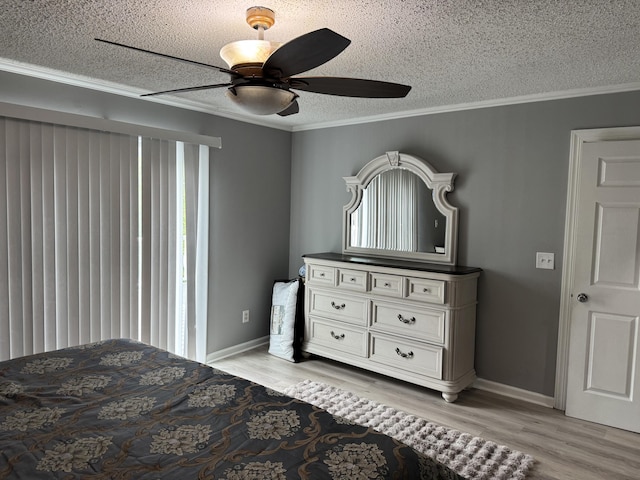 bedroom with a textured ceiling, light wood finished floors, baseboards, a ceiling fan, and ornamental molding