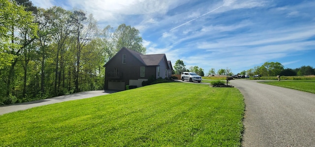 73 Redwood Ln, East Bernstadt, KY 40729 - view of side of home with driveway, a yard, and a garage