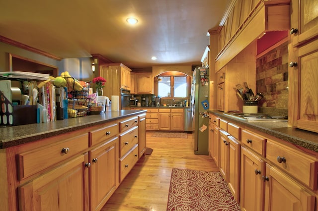 73 Redwood Ln, East Bernstadt, KY 40729 - kitchen featuring a sink, appliances with stainless steel finishes, decorative backsplash, light wood-style floors, and recessed lighting