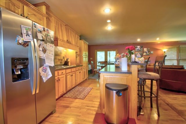73 Redwood Ln, East Bernstadt, KY 40729 - kitchen with stainless steel refrigerator with ice dispenser, a breakfast bar area, light wood finished floors, a center island, and recessed lighting