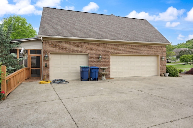 187 Woodside Dr, Somerset, KY 42503 - view of side of property featuring brick siding, concrete driveway, and roof with shingles