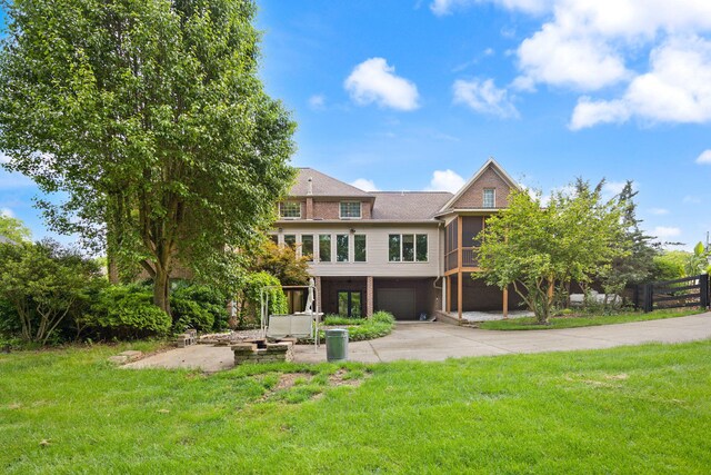 187 Woodside Dr, Somerset, KY 42503 - rear view of house featuring driveway, an attached garage, and a sunroom