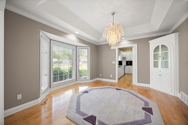 187 Woodside Dr, Somerset, KY 42503 - empty room with a chandelier, light wood finished floors, a raised ceiling, crown molding, and baseboards