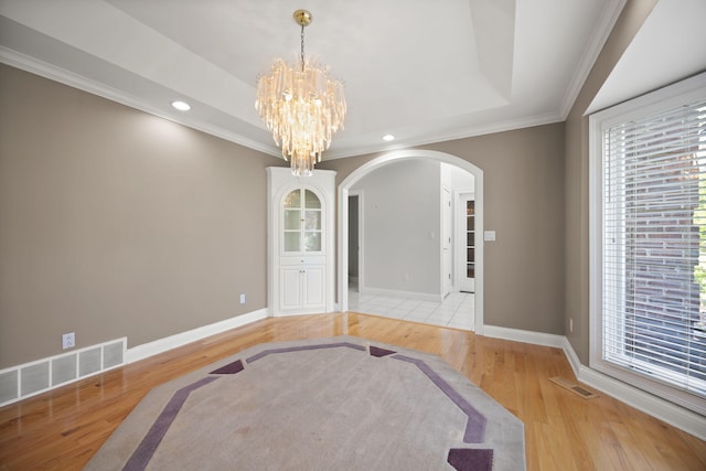 187 Woodside Dr, Somerset, KY 42503 - unfurnished dining area with arched walkways, light wood finished floors, a chandelier, baseboards, and ornamental molding