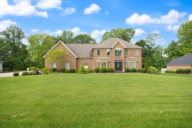 187 Woodside Dr, Somerset, KY 42503 - colonial-style house with a front yard and brick siding