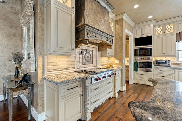 kitchen with stainless steel gas stovetop, dark wood-style floors, decorative backsplash, ornamental molding, and recessed lighting