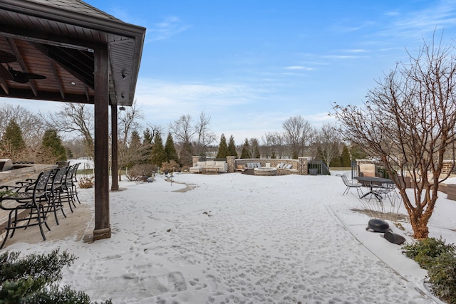 snowy yard featuring a fire pit